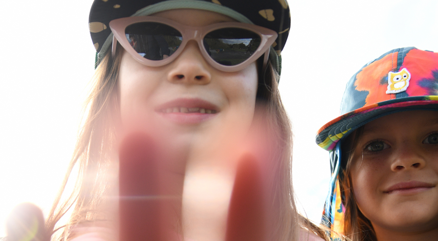 Two girls in summer look into the camera