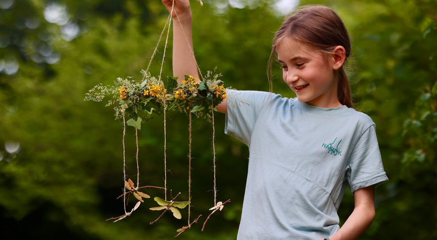 girl with a dragonfly mobile made of natural material