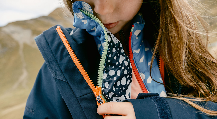 A child connecting his namuk zip-in jackets
