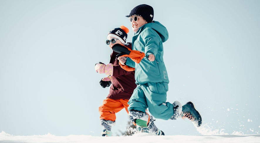 kids in namuk gear running through the snow