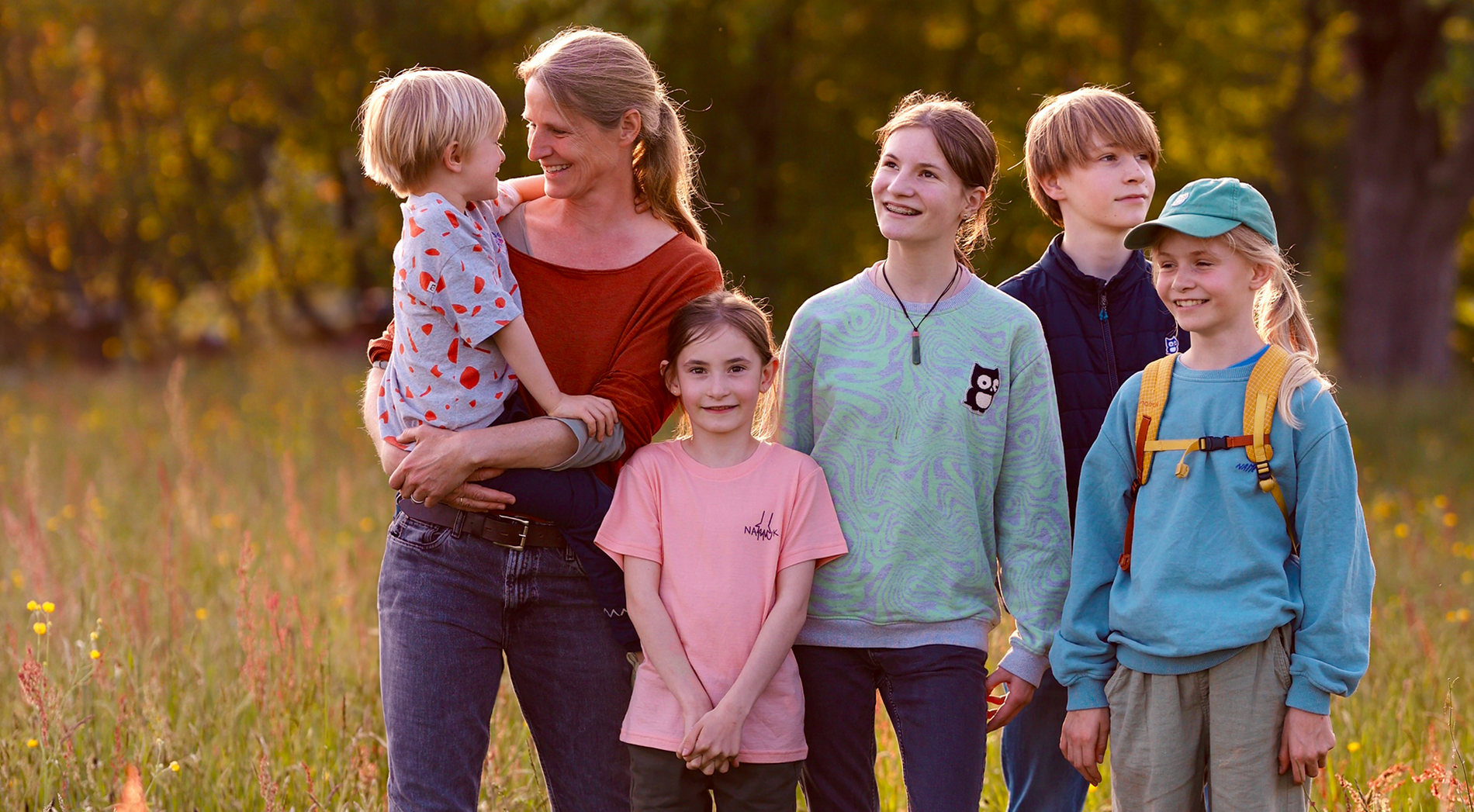 Happy family stands together in nature