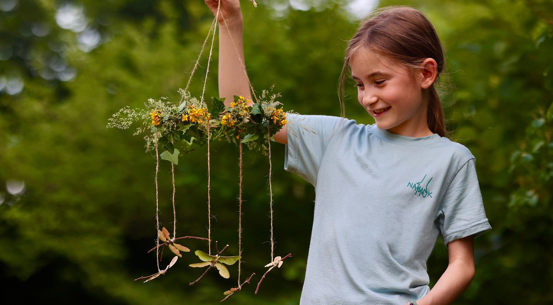 girl with a DIY dragonfly mobile