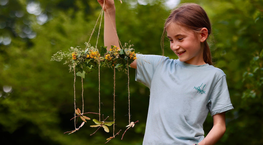 girl with a DIY dragonfly mobile